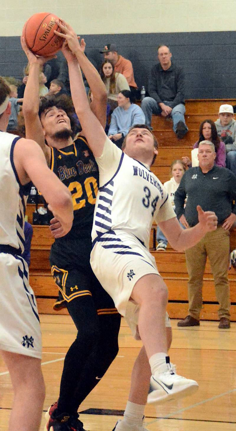 Nodaway Valley senior Jacob Fry (34) disrupts a shot attempt by MStM's Dominic Yates last week.