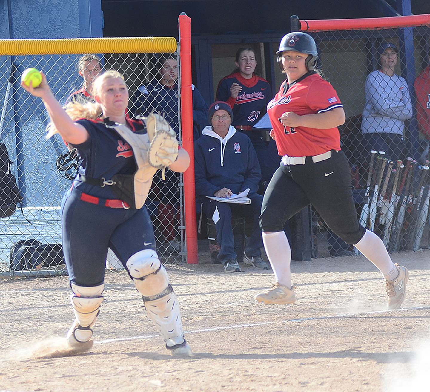 Southwestern catcher Lily McCrae throws to first base to complete a double play after receiving a throw from pitcher Erika Kruse in a bases-loaded situation Thursday against North Central Missouri.