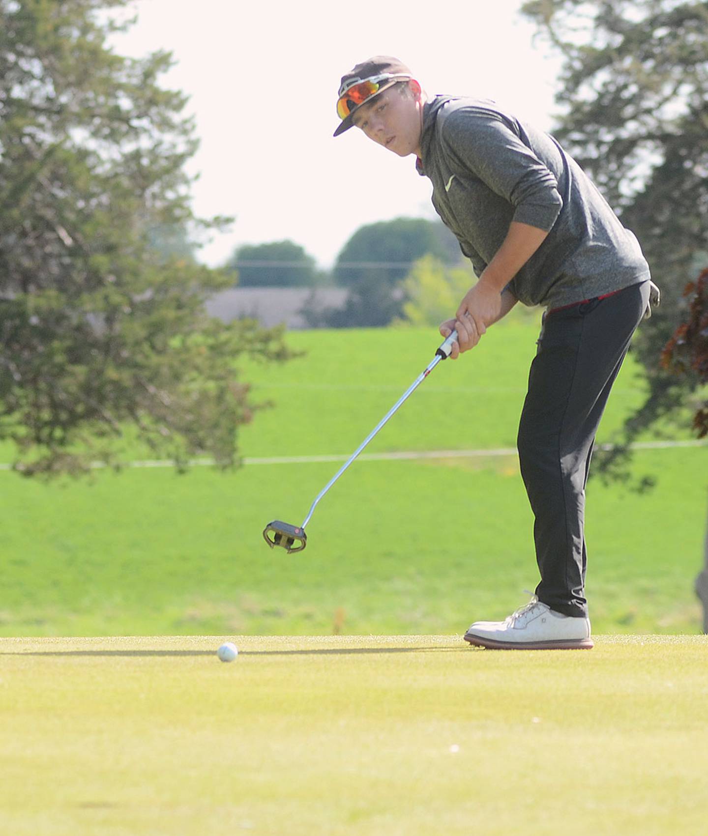 Creston senior Kylen Parsons watches a putt on the No. 3 green at Crestmoor during Friday's dual meet.
