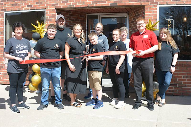Ryan and Morgan Antisdel are joined by family and Greenfield Chamber Main Street leaders April 13 as they cut the ribbon on Moe's RBF (Random Breakfast Food), which opened in January.