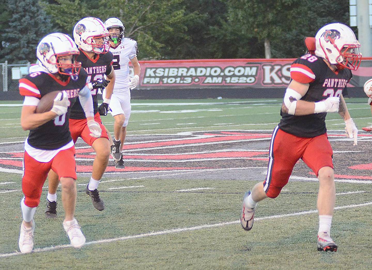 Creston's Cason Scarberry (6) returns an interception with Kal Barber (28) blocking in front.