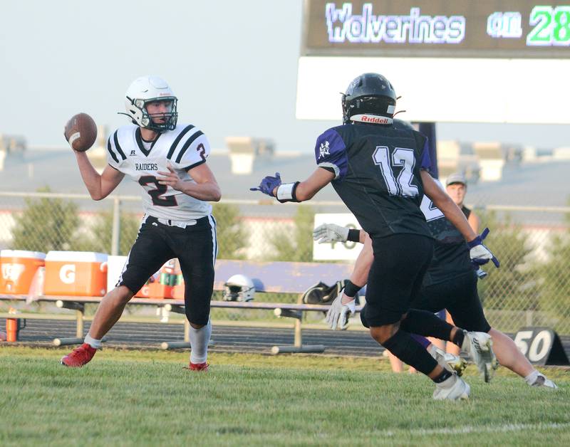 Nodaway Valley/O-M defender Keyin Steeve puts the pressure on Mount Ayr sophomore quarterback Jackson Ruggles Friday in the Raiders' 39-12 victory in the "Battle for the Rock."