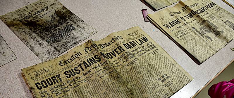 Creston News Advertisers from 1931 and a list of staff names is on display Sunday after the opening of the time capsule in the former LIncoln school building.