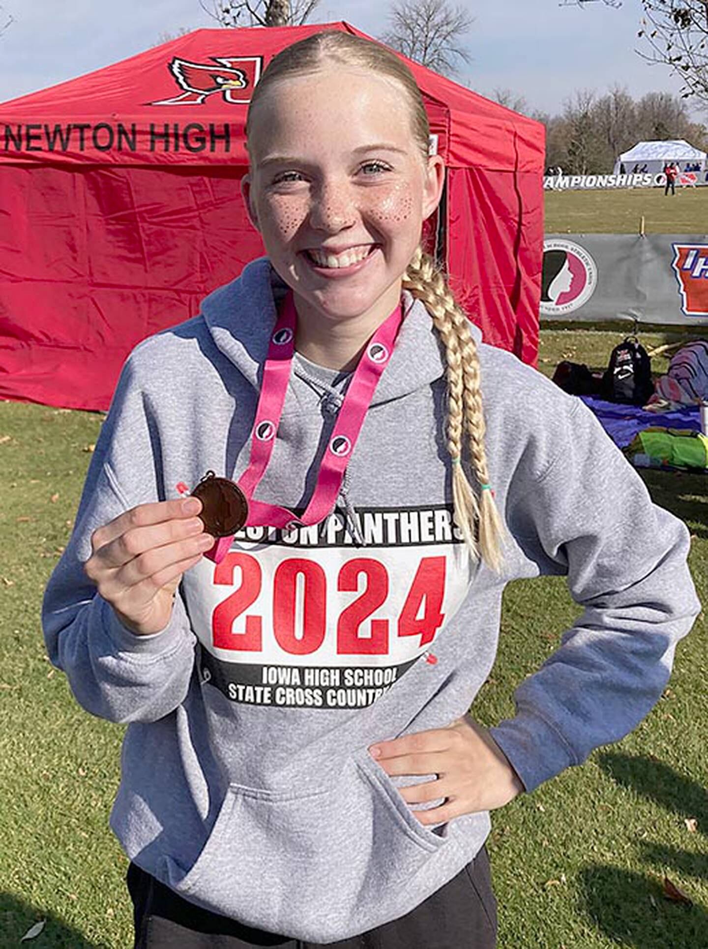 Creston sophomore Reese Strunk shows her Iowa High School State Cross Country Championships participation medal after Friday's race. Strunk was Creston's first state meet runner since 2021.