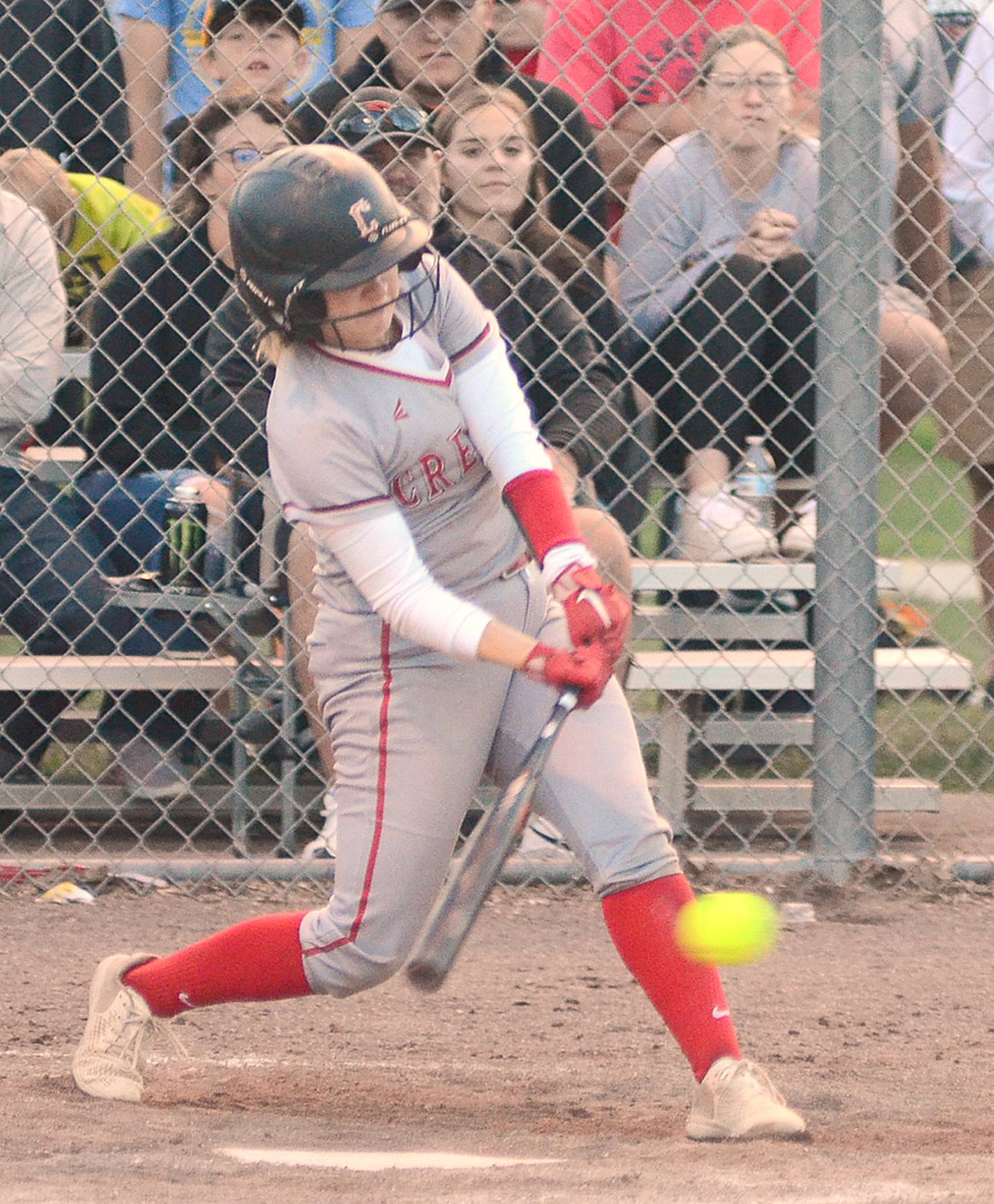Creston senior second baseman Sophie Hagle connects with a low pitch to drive in a run with a single during Creston's four-run rally in the fifth inning Monday at Clarinda.