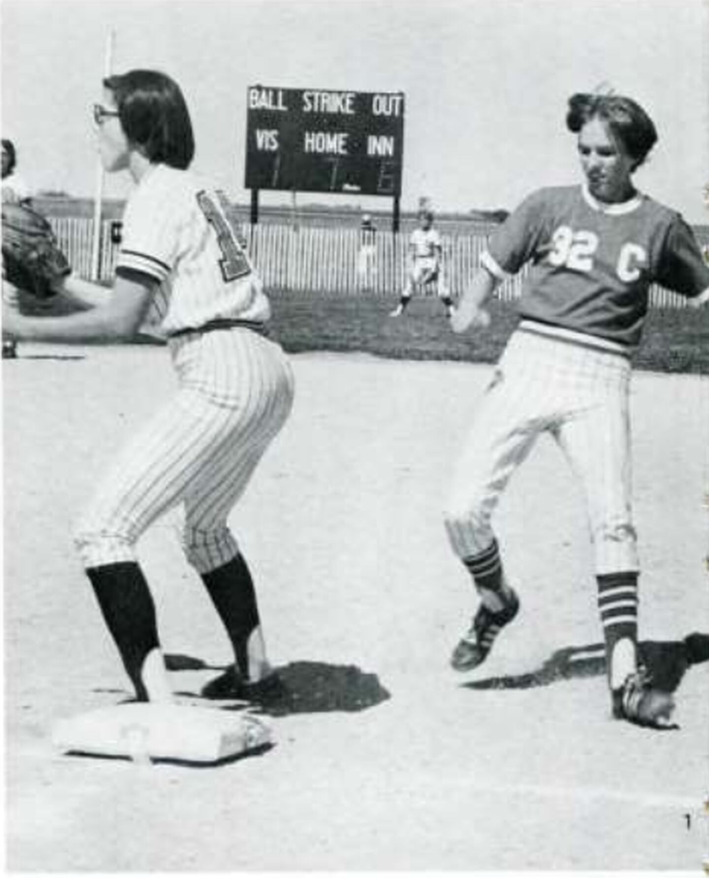 Debra Oxenreider (now Power) runs back to first base during a high school softball game.