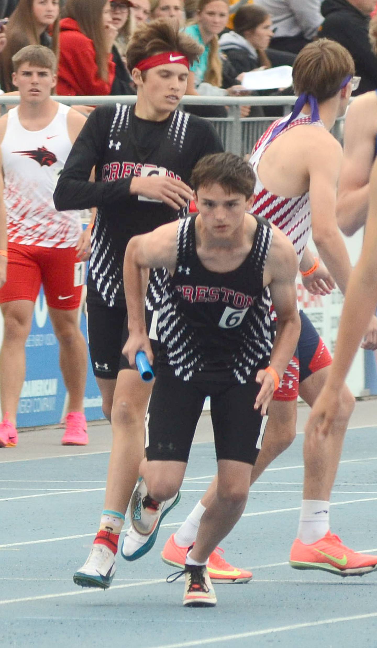 Jace Hanson takes the baton from Ryder Baird in the boys 4x800 relay. Baird had a carry of 2:02 as the Panthers placed 24th in 8:48.89.