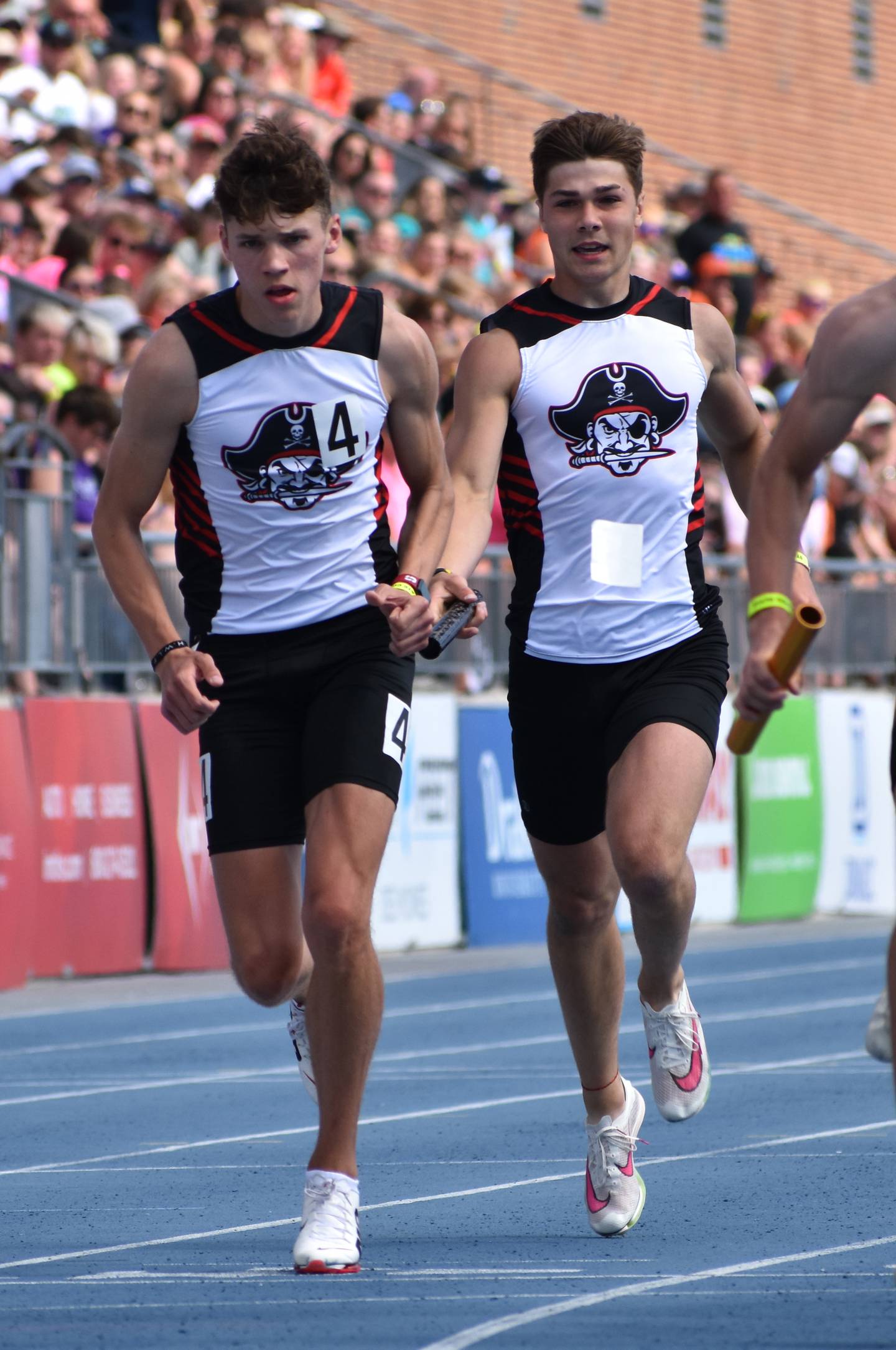 Preston Fleharty hands off to Ryce Reynolds in the winning sprint medley relay.