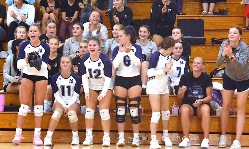 Nodaway Valley/OM's volleyball bench cheers for a good play Thursday, Aug. 28 in a home opener match against the Atlantic Trojans.