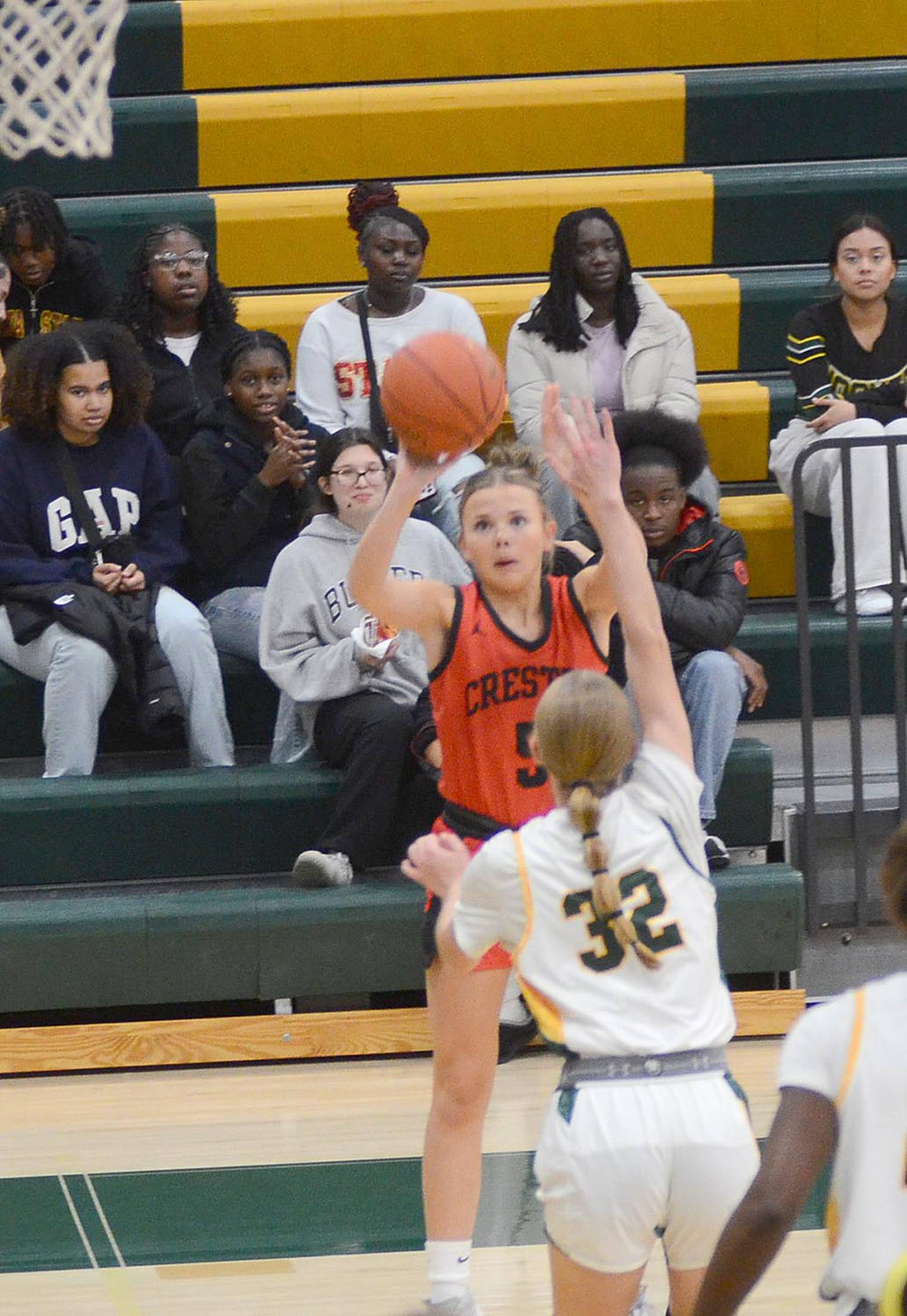 Creston senior guard Ava Adamson launches a 3-point shot against Des Moines Hoover Friday night. Adamson had four points, three rebounds and two steals in the 63-12 win.