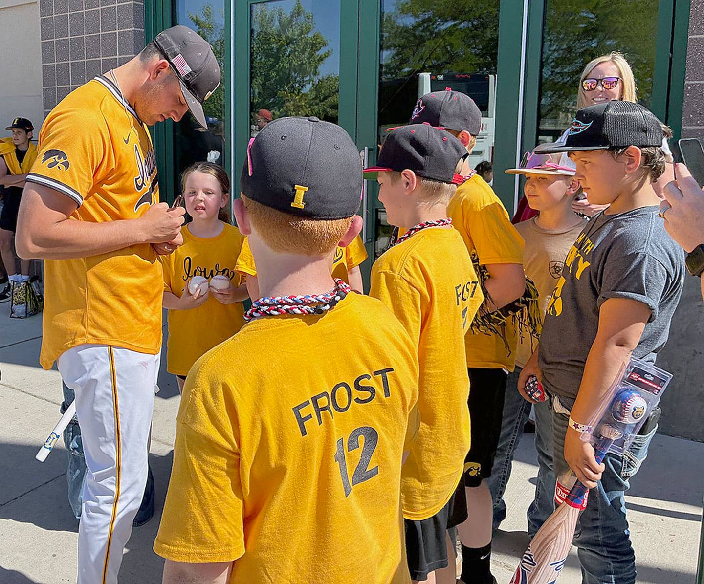 Iowa third baseman Jaixen Frost signs autographs after Sunday's game against Oregon State at Principal Park.