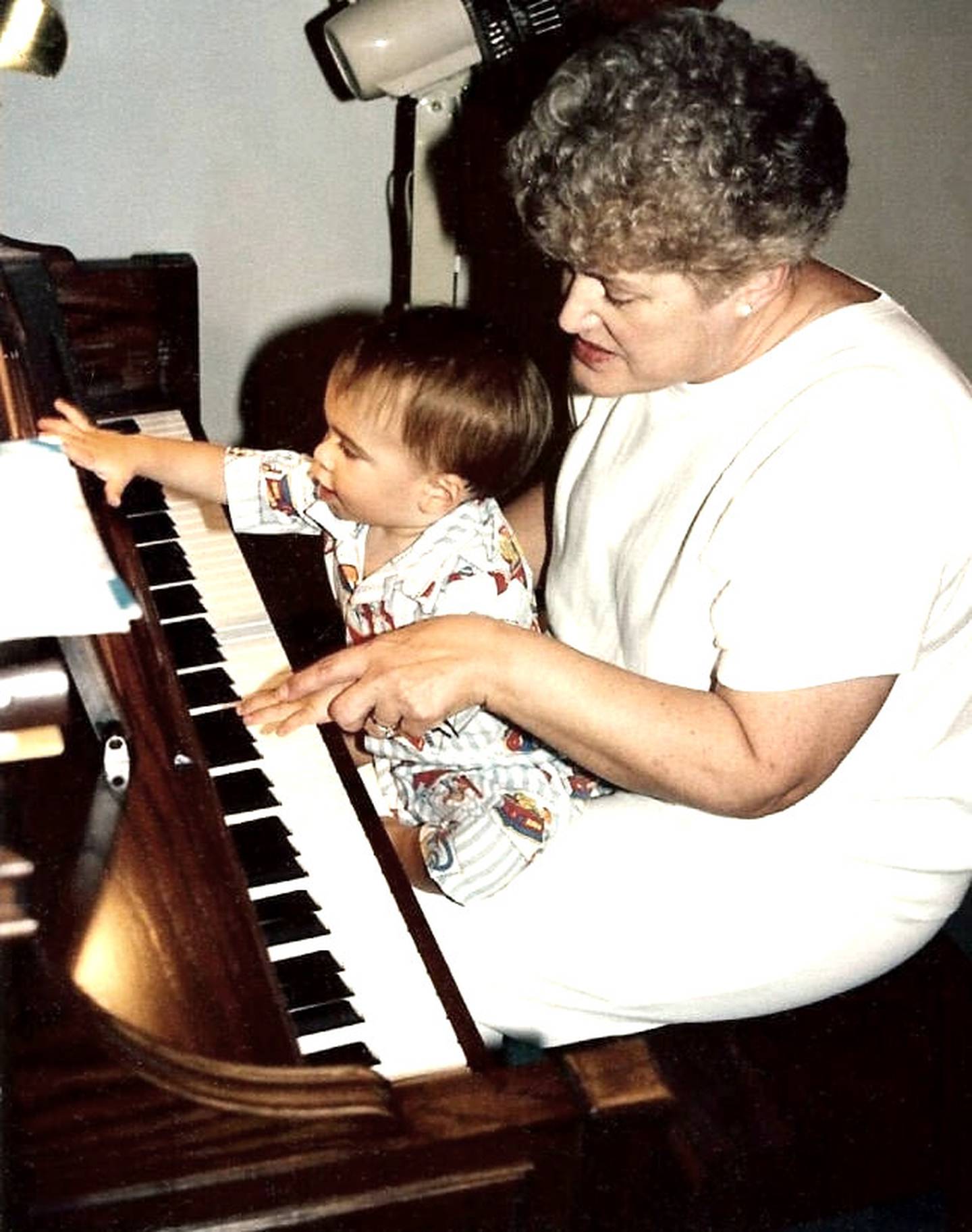 Schultz, a piano teacher, explore the keys on her grandson Nate's first birthday in 1991.