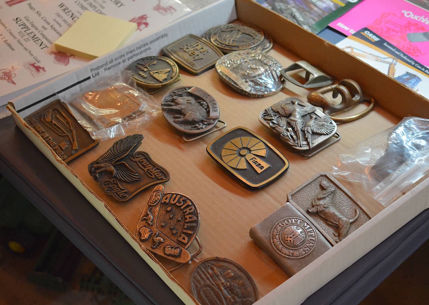 A collection of belt buckles from various implement companies. These collectibles not only serve as unique designs, but in there preservation hold the history of local, national and global companies, both still alive or shuttered.